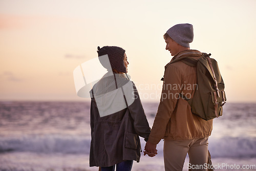 Image of Love so deep that the sea would be envious. a young couple enjoying a romantic evening on the beach at sunset.
