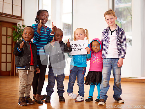 Image of Make our day. a group of children holding up a donate today sign.