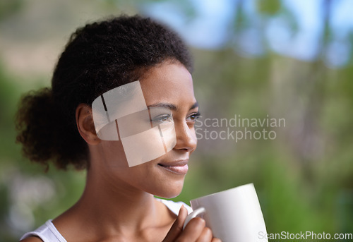 Image of Waking up made easy with a warm drink. a young woman enjoying a cup of coffee.