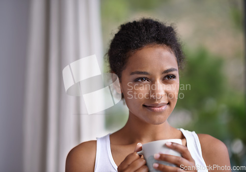 Image of Nothing beats a relaxing warm morning drink. a young woman enjoying a cup of coffee.