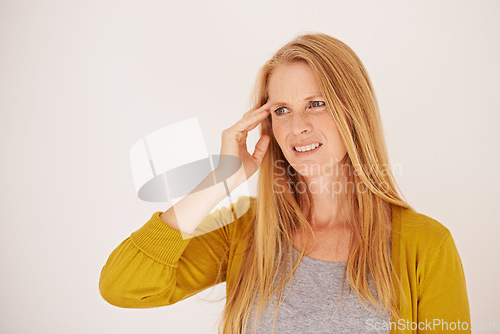 Image of I need a headache pill. a woman in pain with her hand touching her temple.