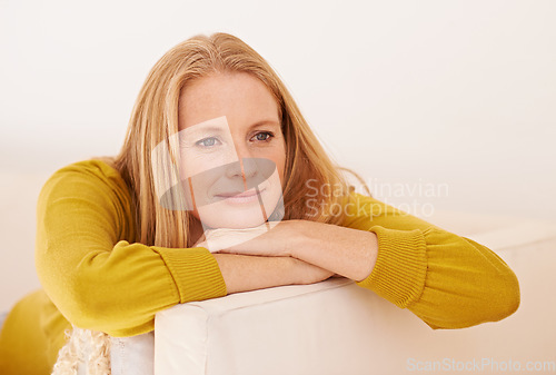 Image of Taking time out from a busy day. a woman relaxing on a couch.