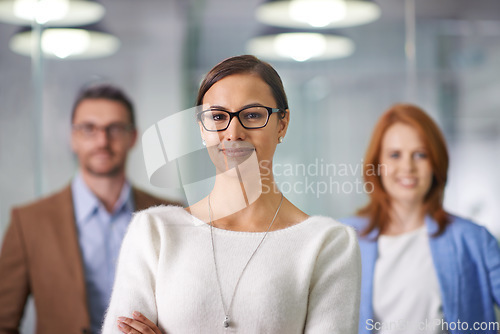 Image of We know the power of teamwork. Portrait of a young businesswoman standing in front of her colleagues.