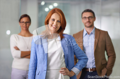 Image of We believe in teamwork. Portrait of a young businesswoman standing in front of her colleagues.