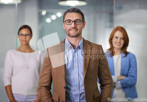 Image of T.E.A.M. - Together Everyone Achieves More. Portrait of a businessman standing with his colleagues.