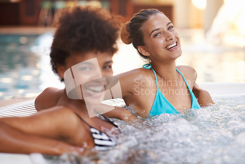 Image of Vacationing in the lap of luxury. Portrait of two gorgeous young women in a jacuzzi.