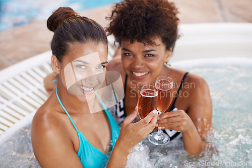 Image of Living it up with my best friend. Portrait of two gorgeous young women enjoying a glass of champagne in a jacuzzi.