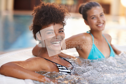 Image of The ladies are having some fun today. Portrait of two gorgeous young women sitting in a jacuzzi.