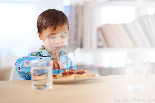 Image of Breakfast is important for a growing boy. A cute little boy eating breakfast.