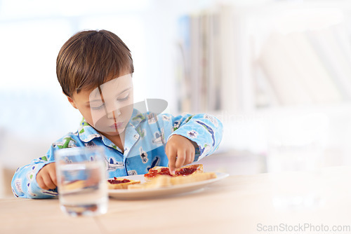 Image of Time to get my breakfast on. A cute little boy eating breakfast.