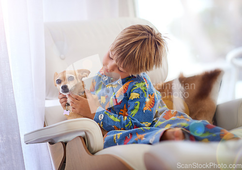 Image of Its just you and me buddy. A little boy petting his dog on the couch.