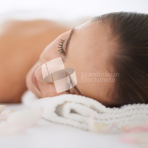 Image of No worries or cares today. Closeup of a beautiful young woman lying on a massage table.