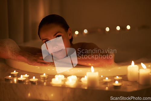 Image of Nothing better than a hot bath for relaxing. a gorgeous woman relaxing in a candle lit bath.