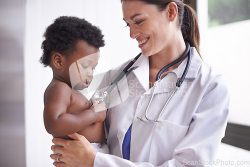 Image of Just in for a routine pediatric checkup. a female pediatrician doing a checkup on an adorable baby boy.