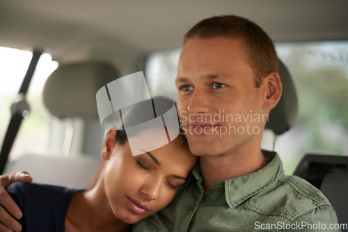 Image of She dreamt of the sandy white beaches they were heading towards. A beautiful woman falling asleep on her husbands shoulder while travelling.