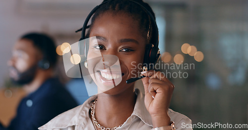 Image of Portrait, happy and black woman at call center on headphones for crm support on bokeh at night. Face, sales agent smile and telemarketing consultant, customer service professional or worker in office