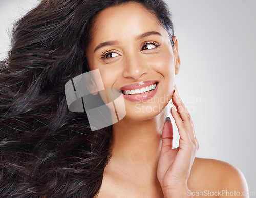 Image of My hair is bouncy and Im loving it. an attractive young woman posing in studio against a grey background.