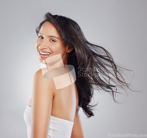 Image of Healthy hair is every girls dream. Cropped portrait of an attractive young woman posing in studio against a grey background.
