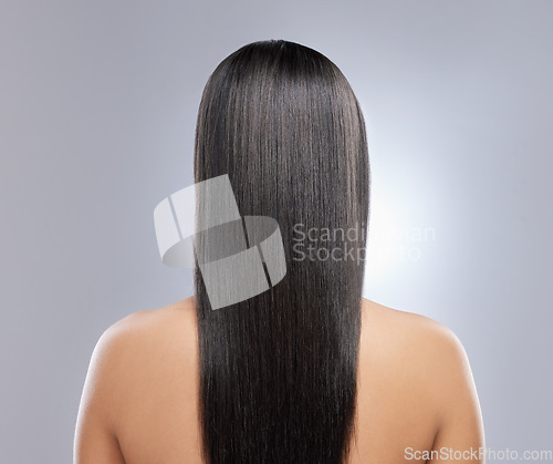 Image of Her hair is healthy and beautiful. Rearview shot of a woman with long brown hair.