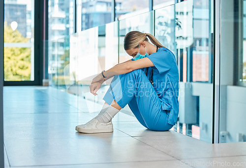 Image of I cant get a break today. a young female doctor looking tired while working in a modern hospital.