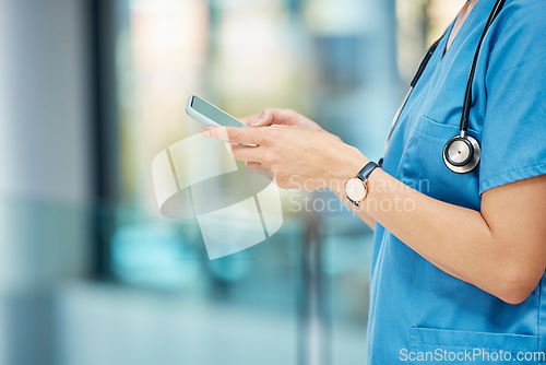 Image of Connected at all times. an unrecognizable doctor using a phone at a hospital.