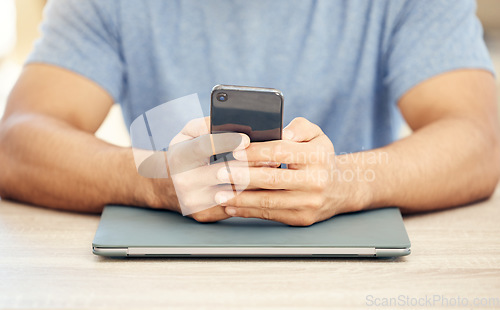 Image of Business never stops. an unrecognizable businessman using a phone in an office at work.