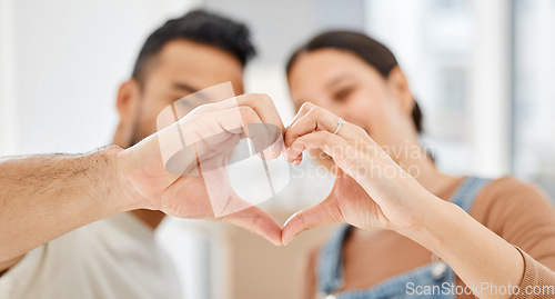 Image of I cant wait to raise a family with you in this loving home. Closeup shot of a couple making a heart shape with their hands while moving house.