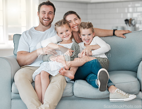 Image of In family life, love is the oil that eases friction. a young family bonding together on a sofa at home.