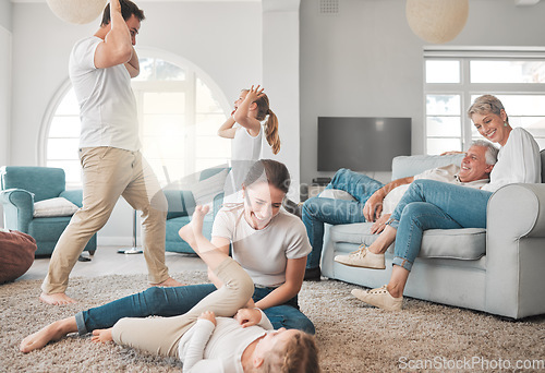 Image of Families are hidden treasures. a young family playing together in the lounge at home.