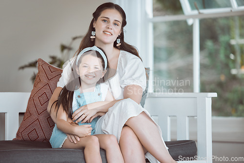 Image of Hope is frail, teach her strength. an adorable little girl relaxing with her mother on the sofa at home.