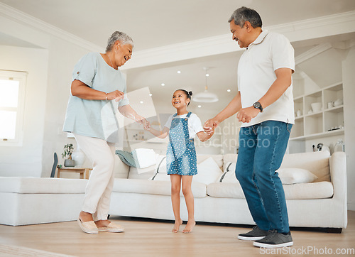 Image of I am blessed to have so many great things. an adorable little girl bonding with her grandparents while dancing with them in the living room.