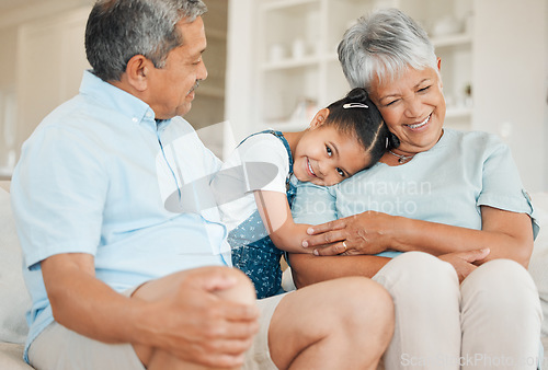 Image of The family is the test of freedom. grandparents bonding with their granddaughter on a sofa at home.