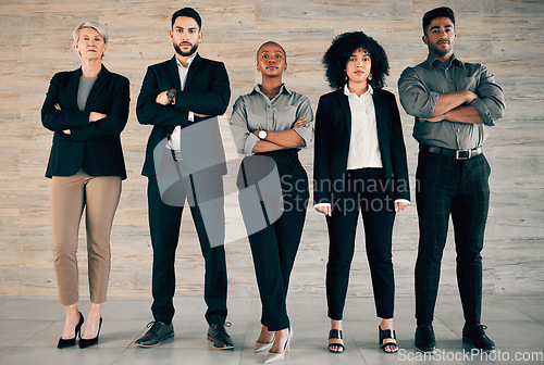 Image of Start by doing what’s necessary. a group of businesspeople standing with their arms crossed in an office at work.