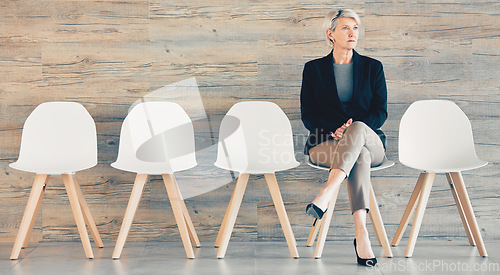 Image of Do the little jobs well. a young businesswoman waiting in line at an office.