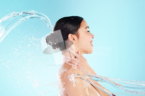 Image of If it doesn’t nourish your skin, let it go. a beautiful young woman being splashed with water against a blue background.