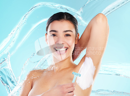 Image of Stay home. Do your skincare. a young woman using a disposable razor to shave her underarms.