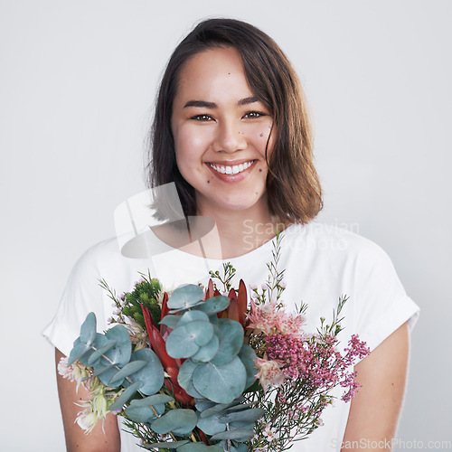 Image of Getting a floral arrangement from a significant other will make anyones day. a beautiful young woman posing with a bouquet against a white background.