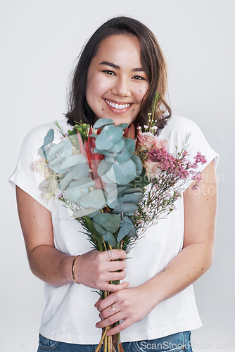 Image of Theres no better way to show your love than with flowers. a beautiful young woman posing with a bouquet against a white background.