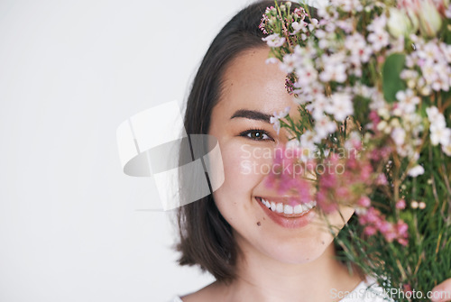 Image of Every woman deserves to be delighted by flowers. a beautiful young woman posing with a bouquet against a white background.