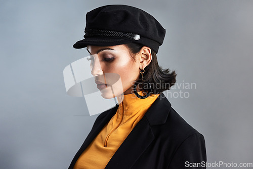 Image of Quiet beauty can speak the loudest. Studio shot of a beautiful young woman posing against a grey background.