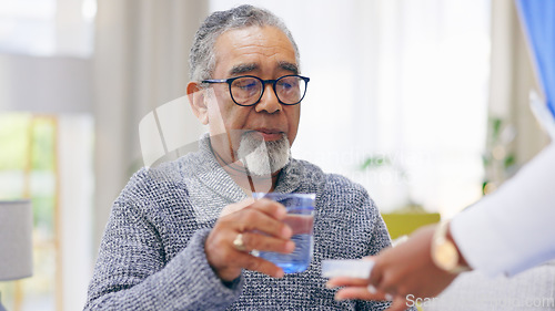 Image of Sick, nurse or senior man in home to take pills or supplements for healthcare vitamins or wellness. Drinking water, medication tablets or caregiver nursing an old person with drugs to help cure virus