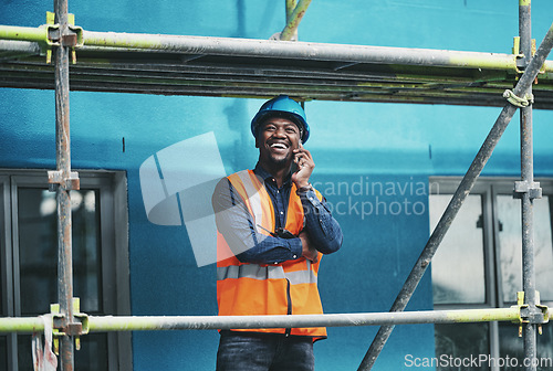 Image of Staying connected to the rest of his team. a young man talking on a cellphone while working at a construction site.