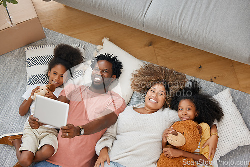 Image of Love is the glue that keeps our family together. a young family spending time together and using a digital tablet at home.