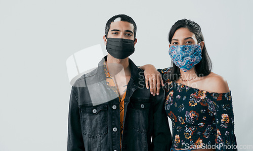 Image of In uncertain times having someone to lean on is invaluable. Studio shot of a masked young man and woman posing against a grey background.