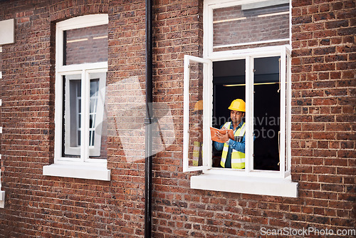 Image of I have so many ideas for this building. a engineer making notes while on a construction site.