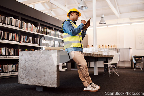 Image of Proper planning is how you make a success of anything. an architect making notes while standing in his office.