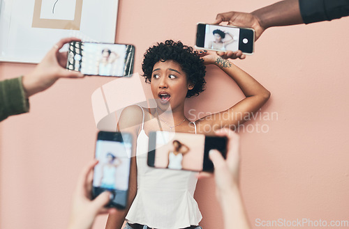 Image of Im always up for a social media photo. a beautiful young woman having her picture taken on multiple phones.