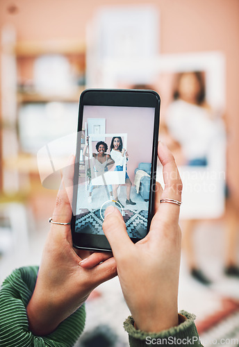 Image of Lets start a trend. two young women posing with a social media prop while having their picture taking on a smartphone.