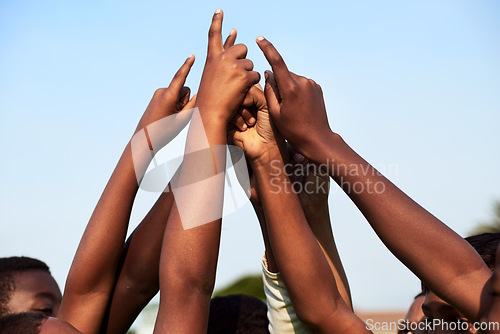 Image of Coming together as champions. Closeup shot of a group of young boys joining their hands together in a huddle.