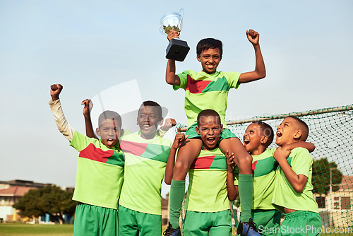 Image of The trophy is ours. Portrait of a boys soccer team celebrating their victory on a sports field.